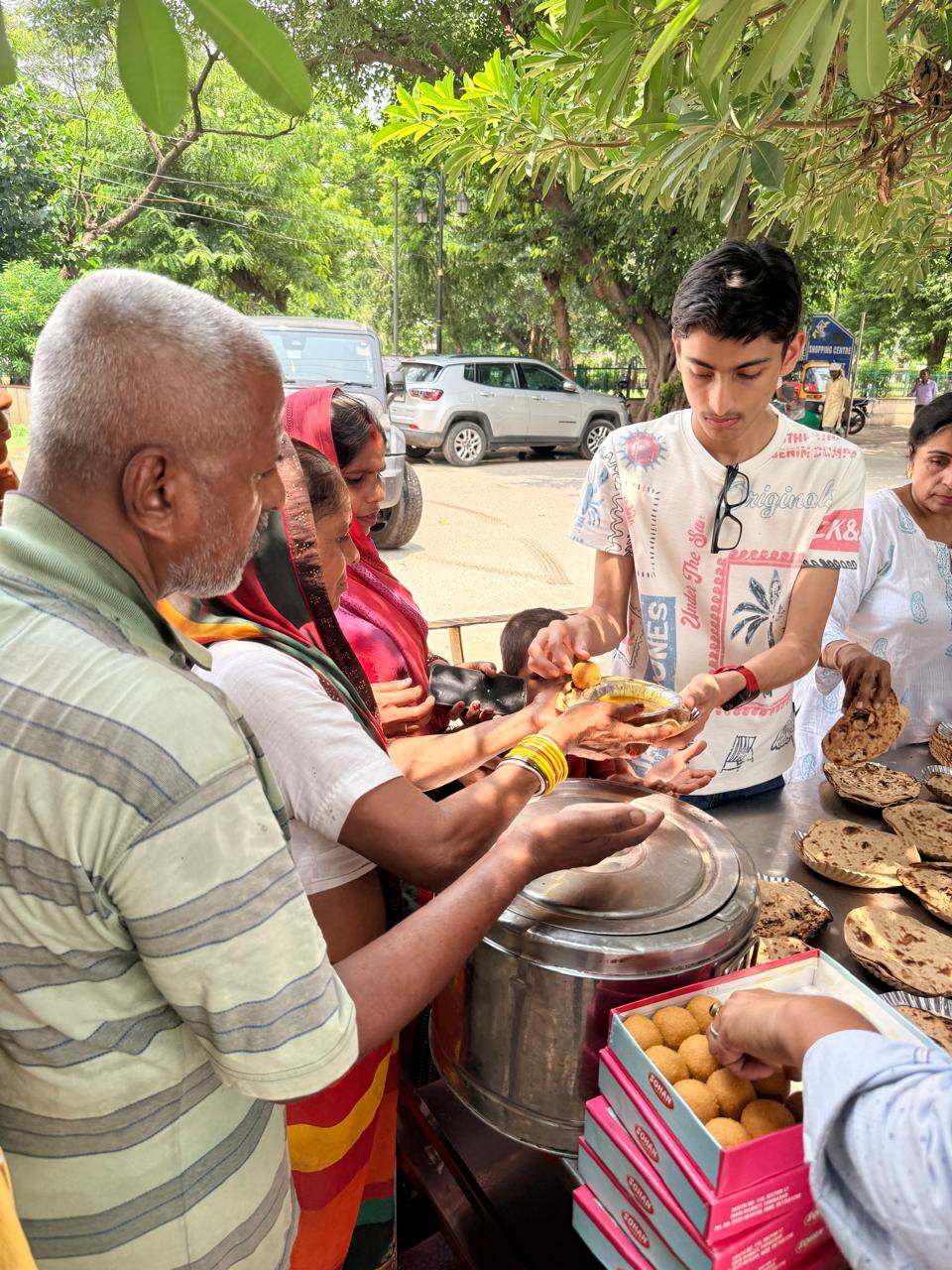 Jinanssh Jain serving food during Nourish All on 11 June 2026 in Sector 14, Faridabad.